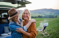 Senior women friends looking at camera outdoors in nature.