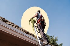 Man working on the roof of a house