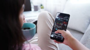 Woman invest online stocks trading on mobile platform app