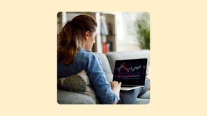 A woman checks her investments on a laptop computer.