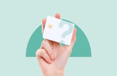 design image of a hand holding up a white credit card with a question mark over it