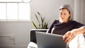 Woman using laptop on couch