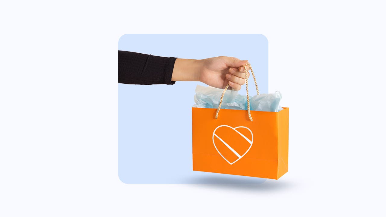 Illustration of hand holding an orange bag with the Southwest Airlines logo on it.