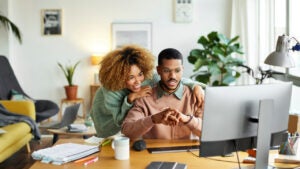 Colleagues Discussing Over Computer At Home Office