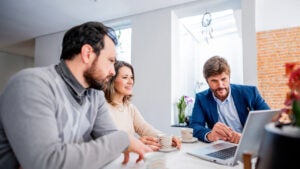 Finance advisor talking to couple at home