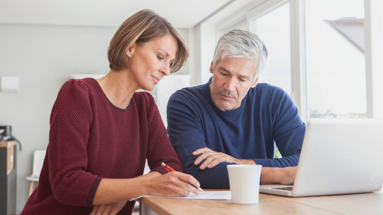 Couple using laptop at home