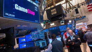 Traders walk the floor during morning trading at the New York Stock Exchange