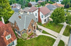 Image of Aerial old brick building in neighborhood with landscaped lawns