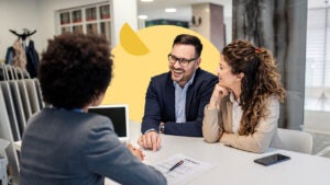 Financial manager meeting with couple in bank branch office