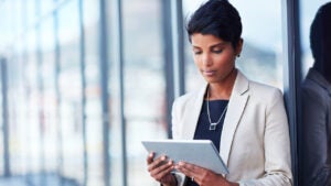 Shot of a young businesswoman using a digital tablet outside of an office