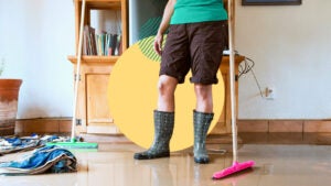 A person standing in boots after a flood.