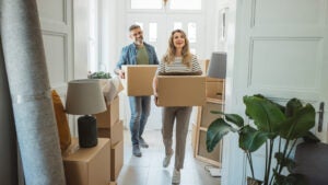 Couple with Moving Boxes in New Home