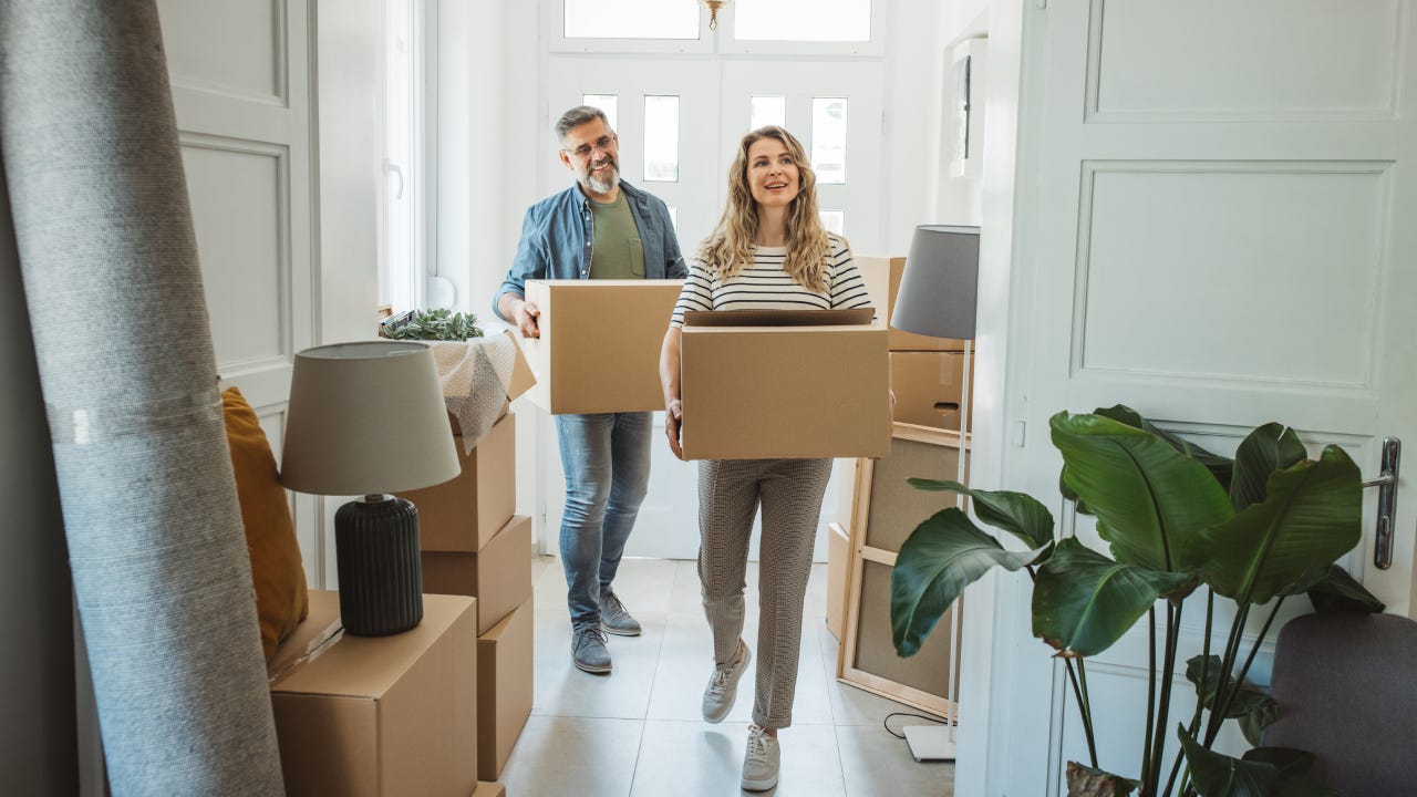 Couple with Moving Boxes in New Home