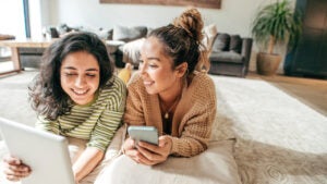 Two people looking at their mobile devices