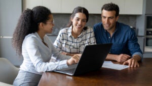 Couple talking to a financial advisor about an investment