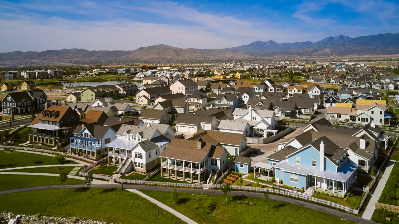 An aerial drone view of a suburban housing development in the summer. Utah, USA