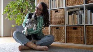 playing with dog on the floor in living room