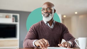 Man typing on a computer, looking happy