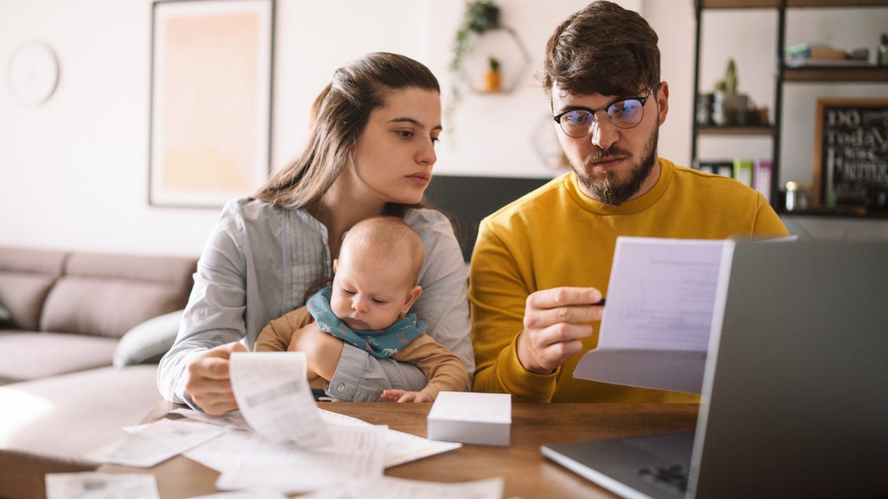 Young family managing budget and paying bills and taxes