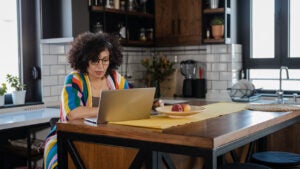 woman using laptop in the kitchen