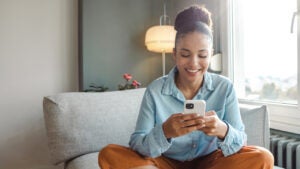 Young woman using a smart phone at home