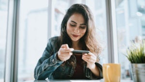 Young Woman Depositing Check With Smartphone