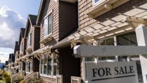 A For Sale sign in front of a home