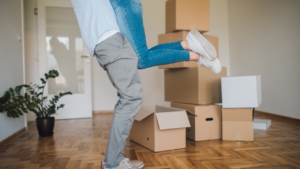 Unknown man lifting woman in a hug at their new place