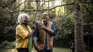 Senior couple laughing and walking in nature