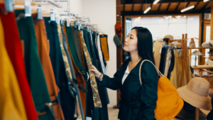 One mid adult woman shopping in a clothing store in Japan