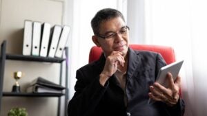 businessman checking online stock market using digital tablet at office desk