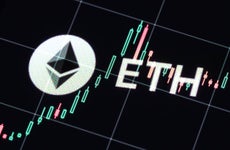 Ethereum logo juxtaposed against candlestick graph