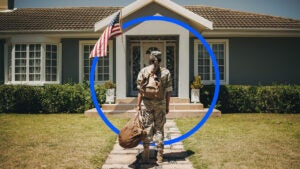 Person walking to the front door of a house