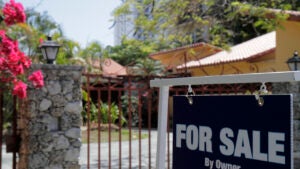 For sale by owner sign outside a house on Flamingo Drive