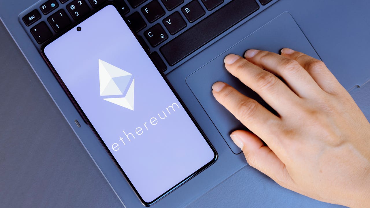 the Ethereum logo is displayed on a smartphone screen