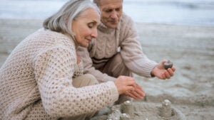 Senior couple making a sandcastle