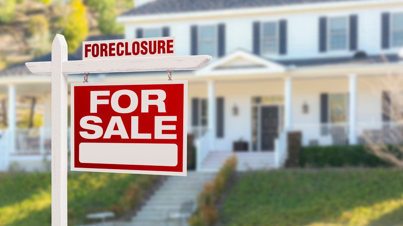 A foreclosure sign in front of a house