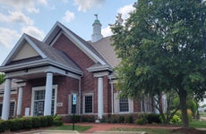 A brick and mortar bank building on a sunny day