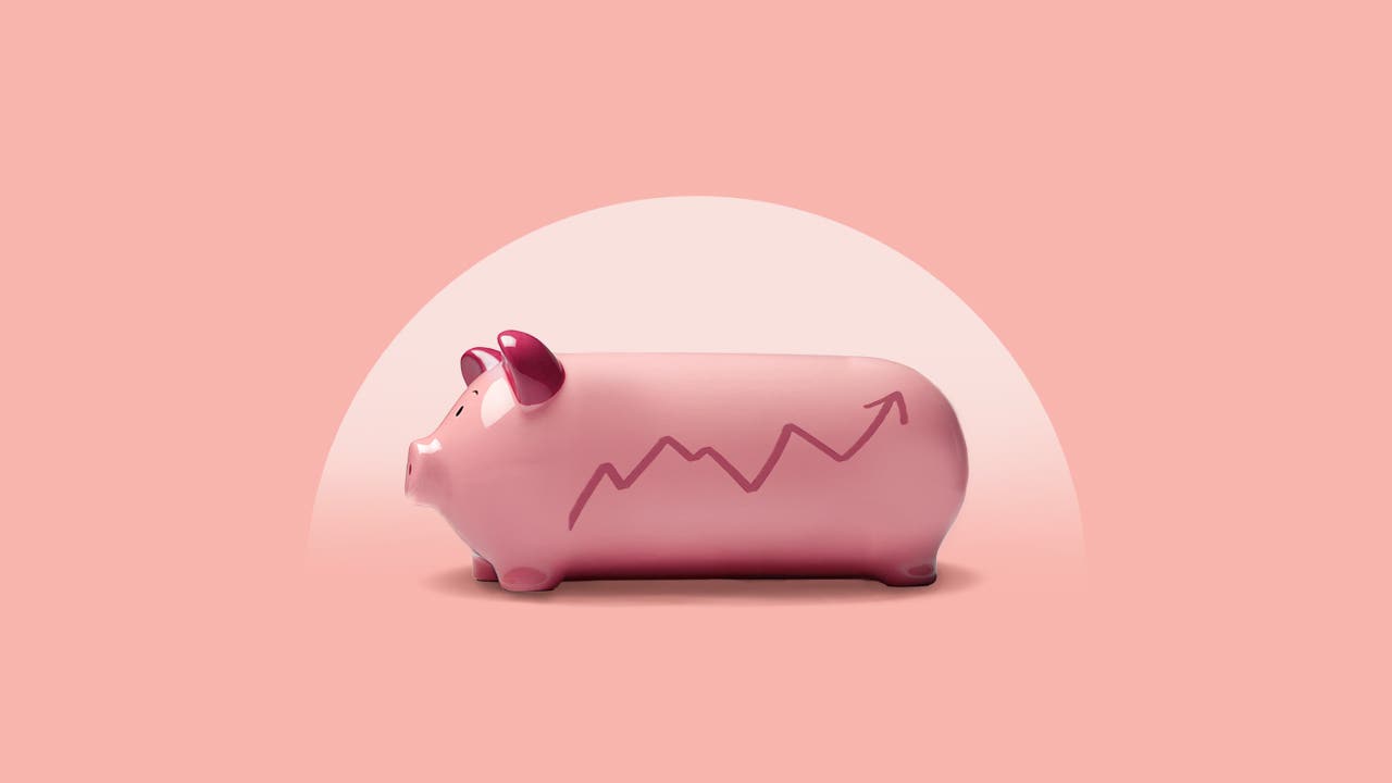 A piggy bank with an upward trending graph on it.