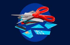 Design element displaying credit cards being cut up with a pair of scissors.