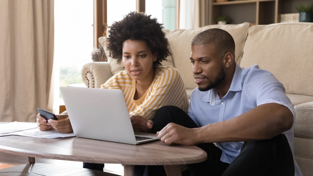 married couple looking at computer screen