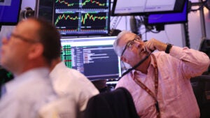 Traders work on the floor of the New York Stock Exchange during morning trading