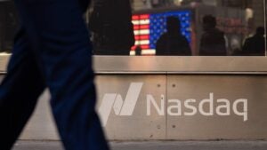 A person walks past Nasdaq headquarters in Times Square in New York City