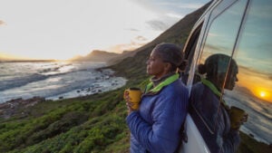 woman enjoying sunset by the sea