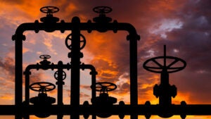 Pipes and valves of the gas pipeline at sunset