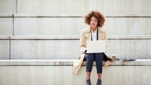 businesswoman with laptop on steps