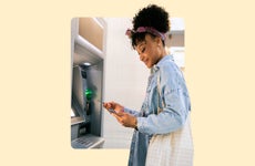 Woman standing in front of an ATM