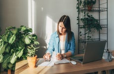 woman calculating bills, money, loan or rent payments, using laptop