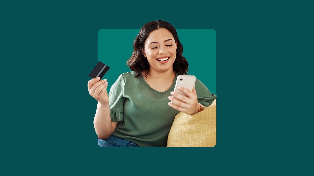 Woman paying a bill on her mobile phone with her bank card