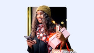 Young Black woman shopping and holding credit card